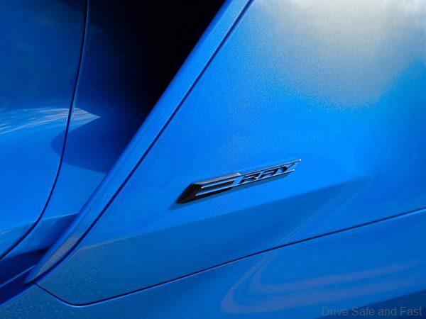Close up view of E-Ray badge on 2024 Chevrolet Corvette E-Ray 3LZ coupe in Riptide Blue. Pre-production model shown. Actual production model may vary. Model year 2024 Corvette E-Ray available 2023.