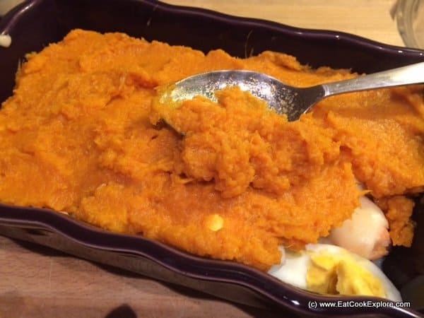 Add mash topping over the fish and egg