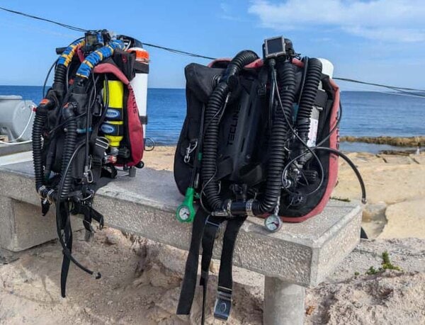 Two Hollis Prism2 rebreathers side by side, one front mounted counterlungs the other back mounted counterlungs
