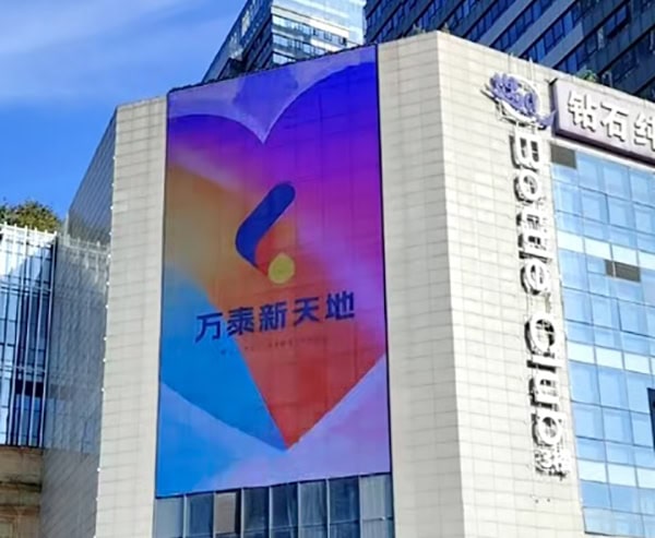 Real-world application of transparent LED mesh display installed on modern building facade