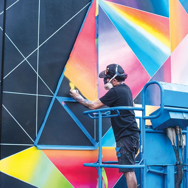 Muralist Jose Digregorio working on a new piece