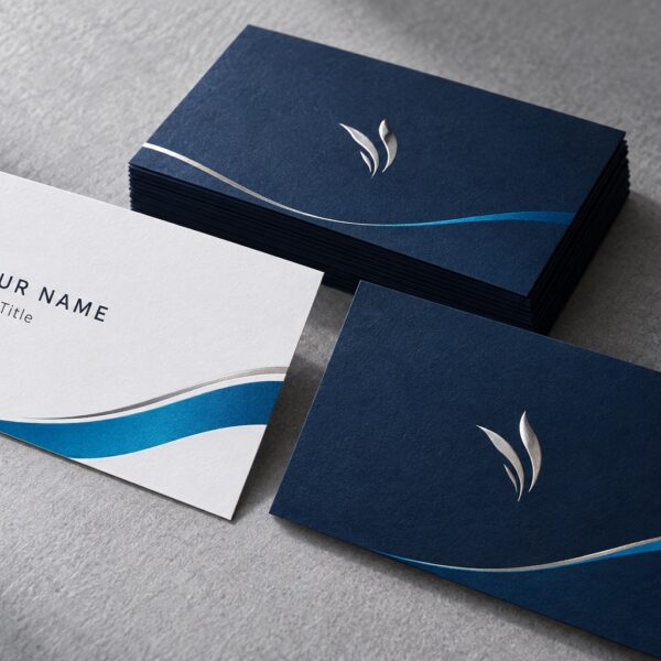 Navy and white business cards with blue accents and silver foil details