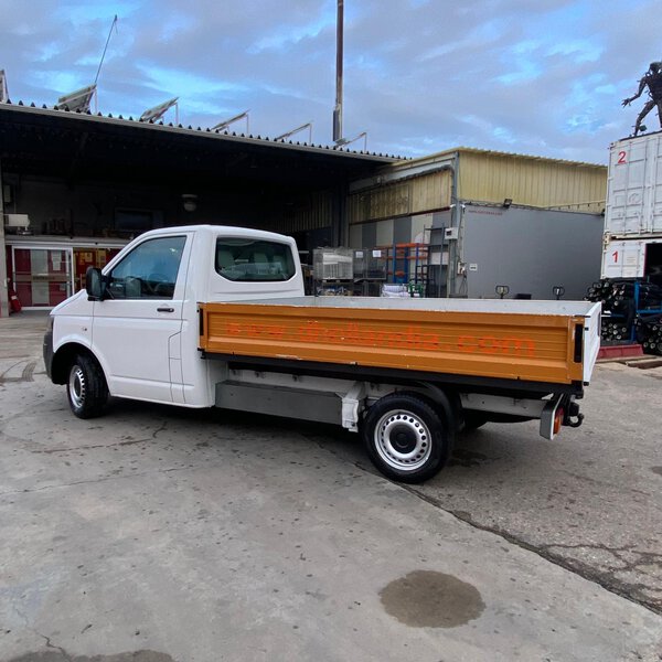 Vista trasera de Volkswagen Transporter con caja abierta y laterales metálicos.