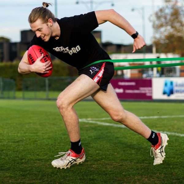Coach providing one-on-one Speed Training to improve sprint mechanics