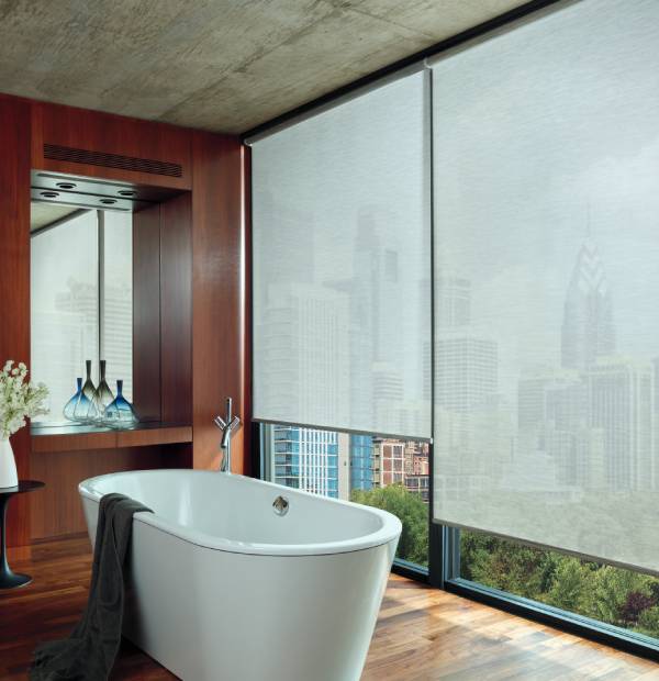 Elegant bathtub overlooking cityscape, high-rise buildings, floor-to-ceiling windows, modern design.