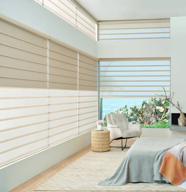 White horizontal window blinds, modern indoor decor, bright and airy bedroom setting.