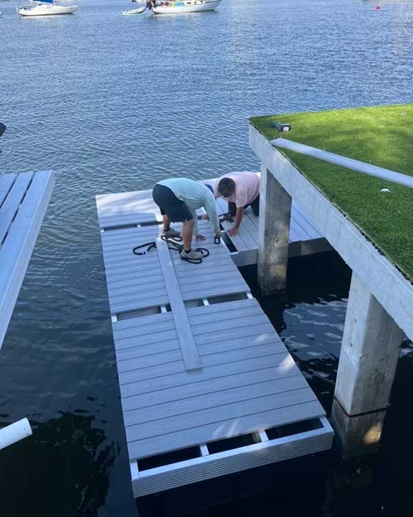 Supreme Marine floating dock installation with two people