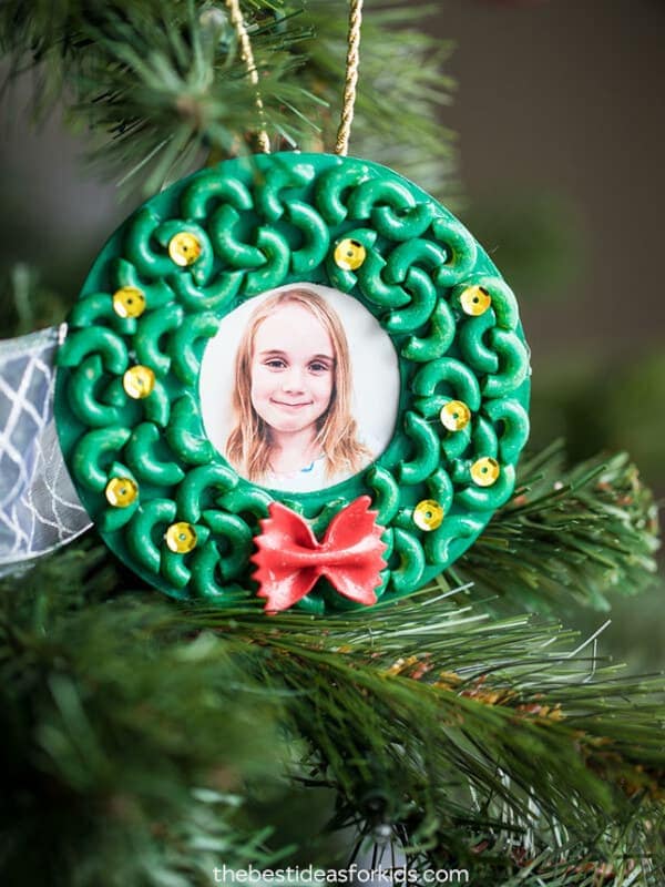 framed pasta portrait ornament with picture of girl hanging from a tree