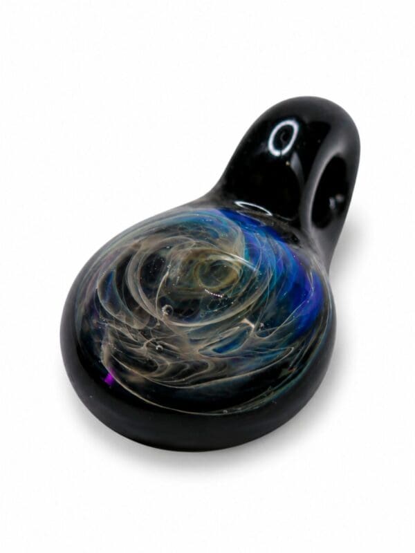 Angled view of Black Nebula Smudge Glass Pendant with black glass loop and blue galaxy-style swirl detail.