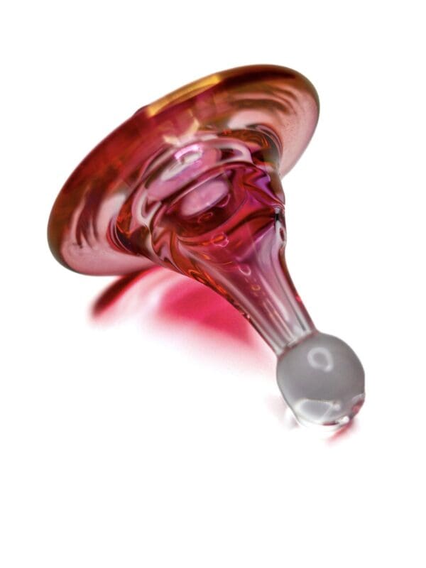 Side view of Ruby Spinner Carb Cap with pink and red glass colourwork, rounded handle, and wide directional cap.