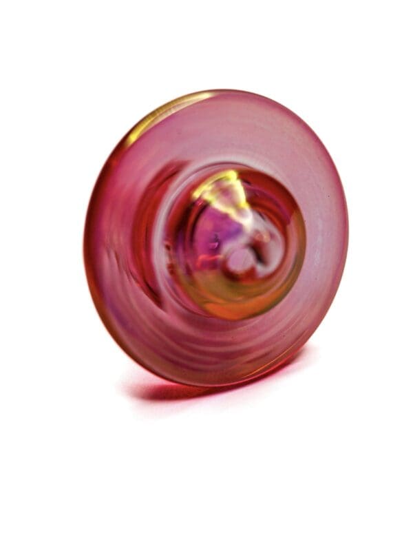 Opalescent pink iridescent carb cap made from glass for use with compatible quartz bangers.