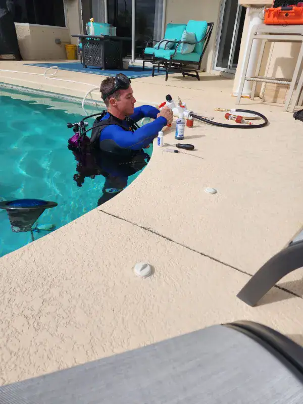 Splash Pool Leak Detection technician performing an in-pool dive inspection to locate a pool leak