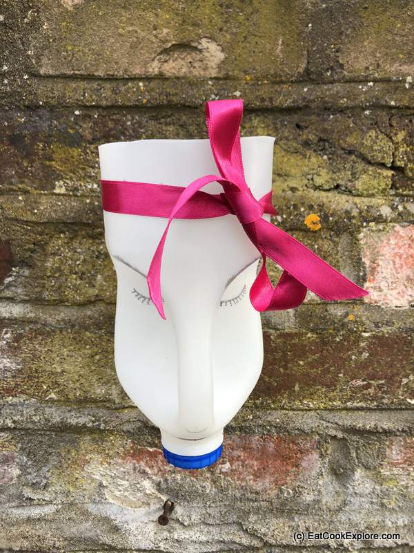 Milk bottle planters - I tied a ribbon across the forehead fo the bigger planter.