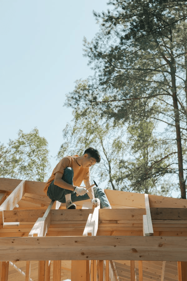 An experienced roofer working on the installation of a roof. Get an estimate today by contacting us.