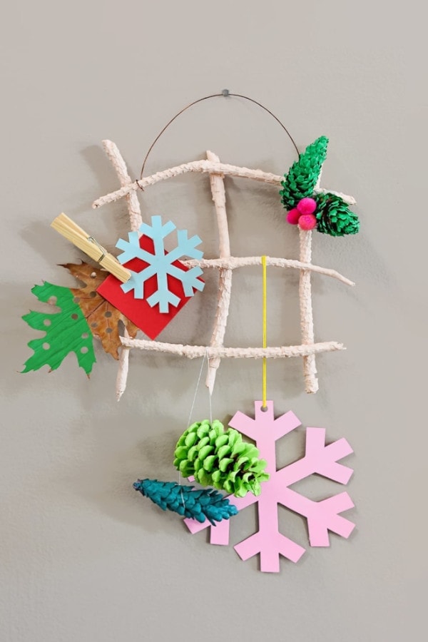 holiday card display made using twigs and pinecones