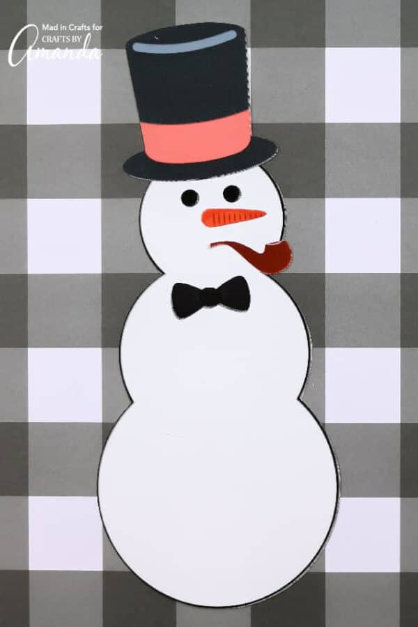 snowman with pipe on its mouth on a black and white checkered backdrop