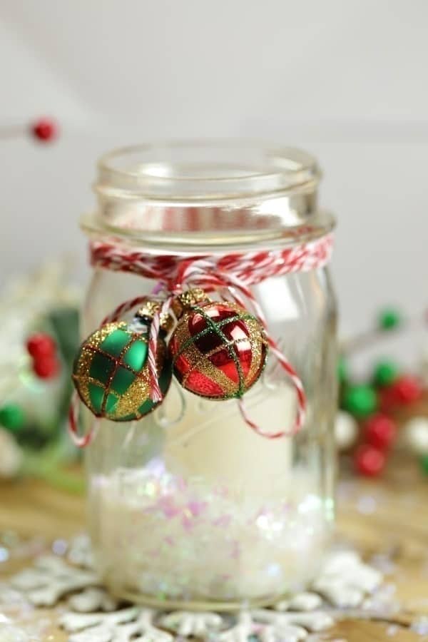 Set the mood and create a welcoming holiday home this Christmas with these pretty Mason Jar Christmas Candles.  #masonjar #masonjarcrafts #ChristmasDecorations #Christmasdecor #Christmascrafts #Xmasdecorations #Xmascrafts