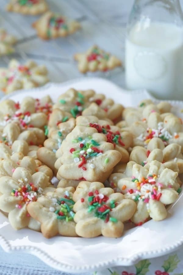 These classic Spritz Cookies are rich, buttery and a must-have cookie for Christmas. Rumor has it that they are Santa's favorite too. #SpritzCookies #ChrismtasCookies #CookieRecipe #holidaybaking #holidayrecipes #Christmascookieexchange #Christmascookierecipe