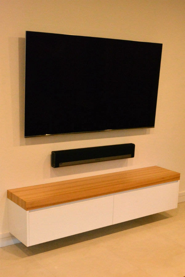Custom made free floating entertainment unit with black butt top and led down lights. Custom made joinery and cabinet making.