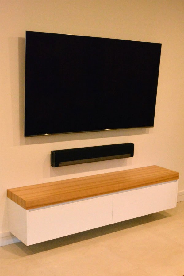 Custom made free floating entertainment unit with black butt top and led down lights. Custom made joinery and cabinet making.