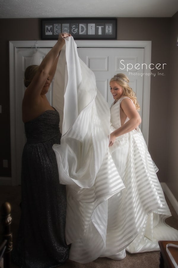 bride putting wedding dress on in chagrin falls home
