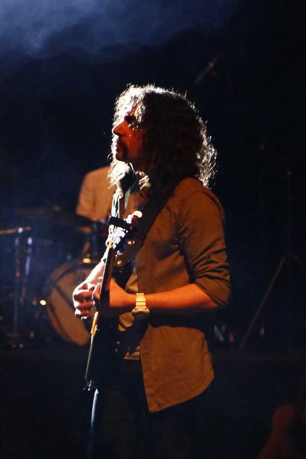 Dariush Meshkin playing electric guitar live