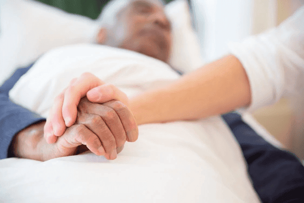 Doctor providing emotional support and palliative care for seniors.