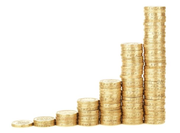 Stack of coins growing, representing frugal living and financial freedom