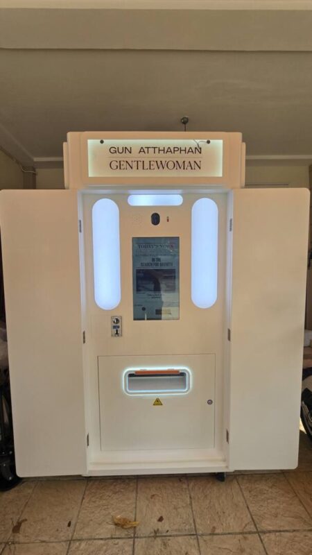 Standard white newspaper photo booth with lit side panels, ready for a wedding or event
