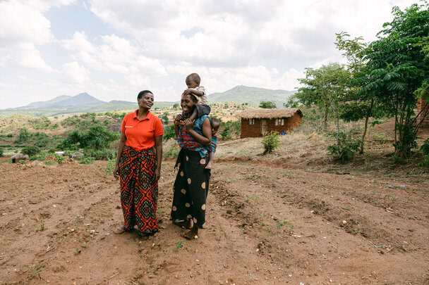 Sara Chasowa, (left), a Save the Children Gender Facilitator, meets with Unica, a farmer and mother of three at her family farm in Malawi