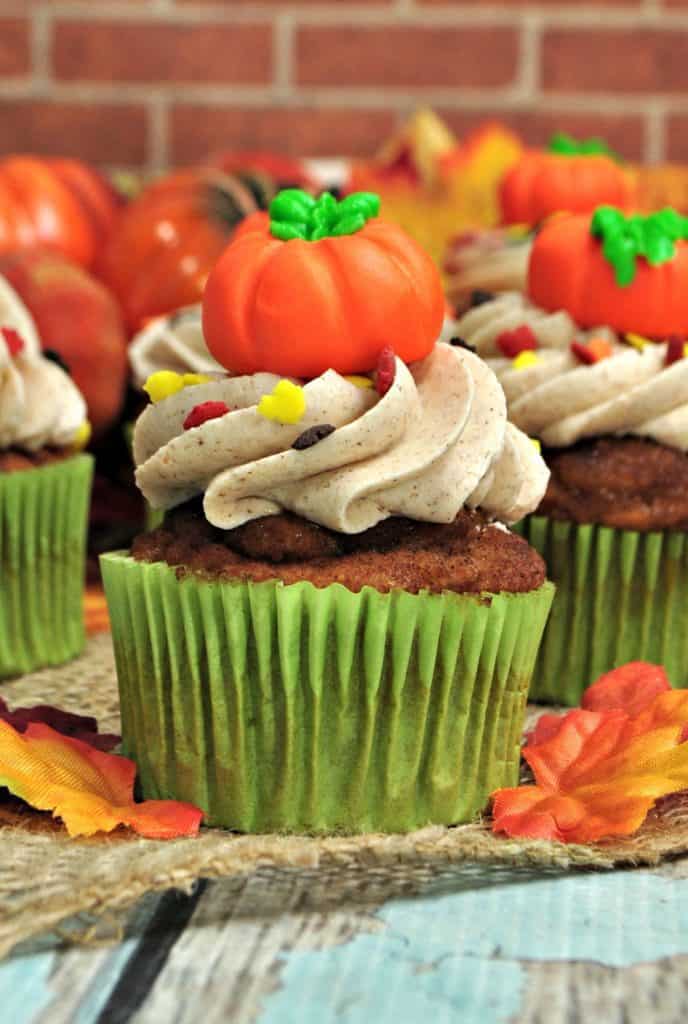 Pumpkin Spice Cupcakes are the perfect way to celebrate the fall season. They are full of pumpkin spice and topped with a sweet cinnamon buttercream frosting. #pumpkinspicecupcakes #pumpkinrecipe #fallbaking #pumpkindessert #cupcakes