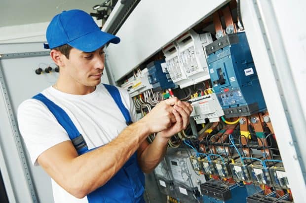 electrician franchise employee installing commercial power board