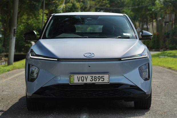 front of the Perodua QV-E in Ice Blue