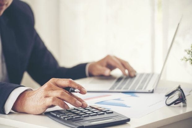 person calculating if they can replace  salary fast with a franchise