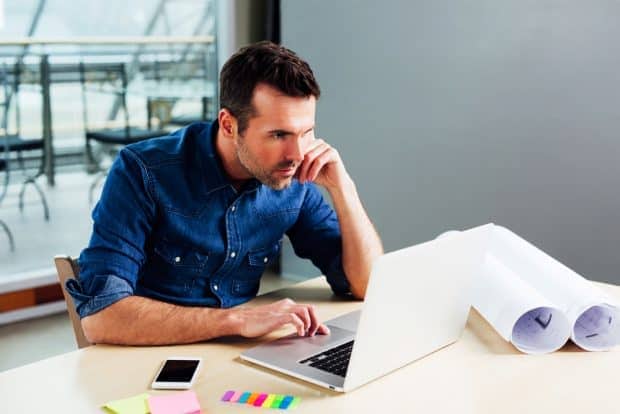 person figuring out how much it costs to buy a franchise