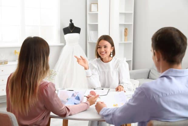 image of couple with wedding planner who started her own business