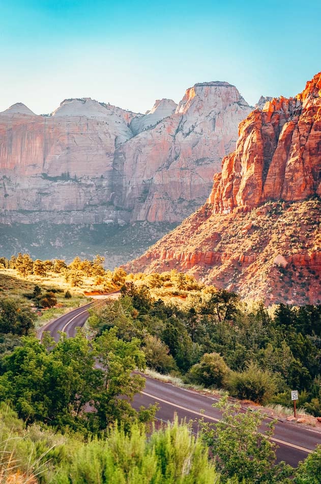 View of landscape and mountains and a winding road in Zion National Park.