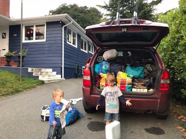 Kids packing for a road trip. Best car games for kids cover