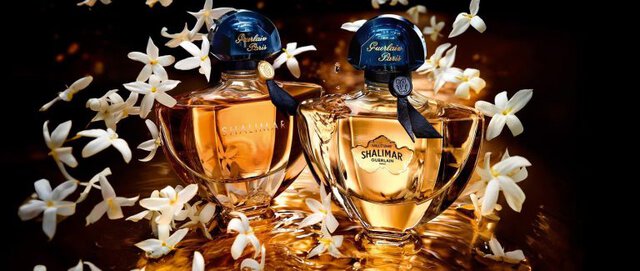 Guerlain fragrance collection bottles arranged by year, from 1860 to 2025