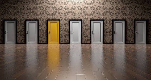 Row of modern doors with one yellow door in a stylish interior.