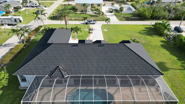 Black shingle roof of an L shaped house done by Ledgewood Roofing & Construction in Florida.