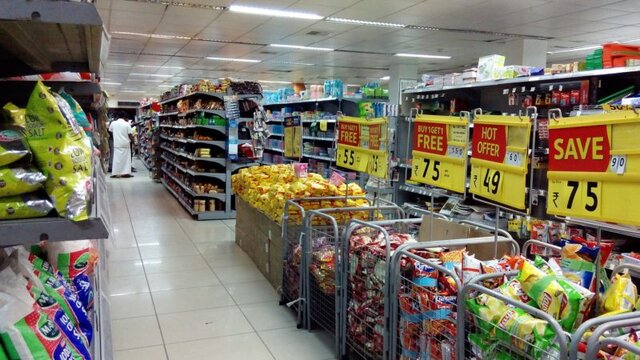 Supermarket aisle representing frugal grocery shopping