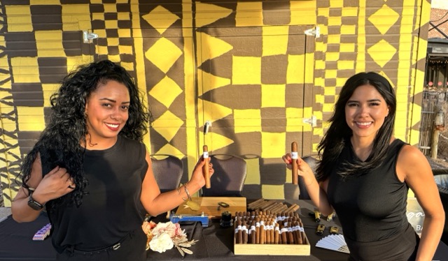 Two professional female Cigar Bella rollers presenting cigars at a luxury event near Spicewood Texas
