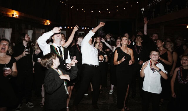 Wedding guests dancing in barn