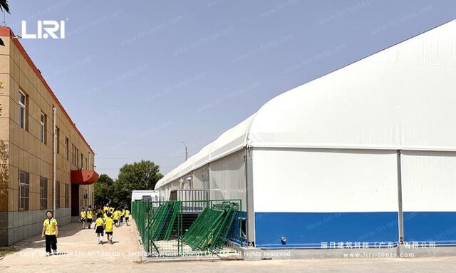 School natatorium tent exterior with white canopy and blue base