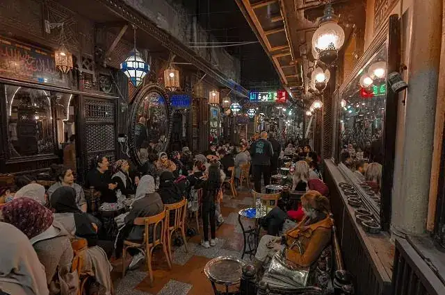 Historic café alley with tables and lanterns in Khan El Khalili