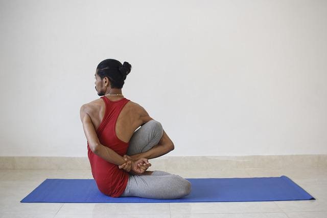 man practising yoga