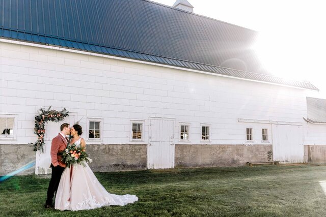 Wedding couple outside of barn