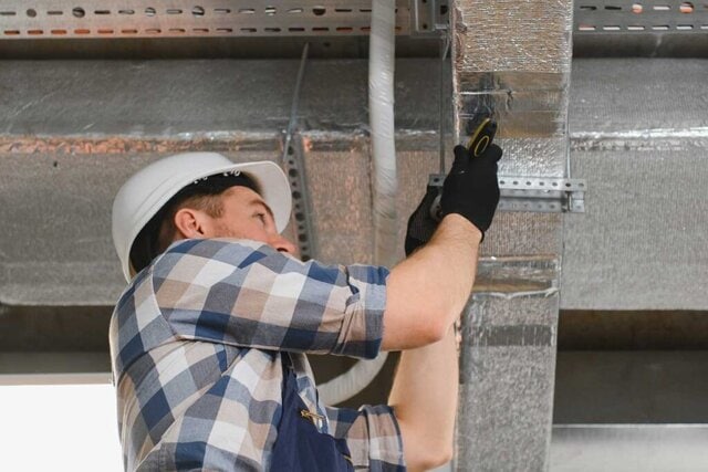 A FreeflowAir engineer sealing some pipework.