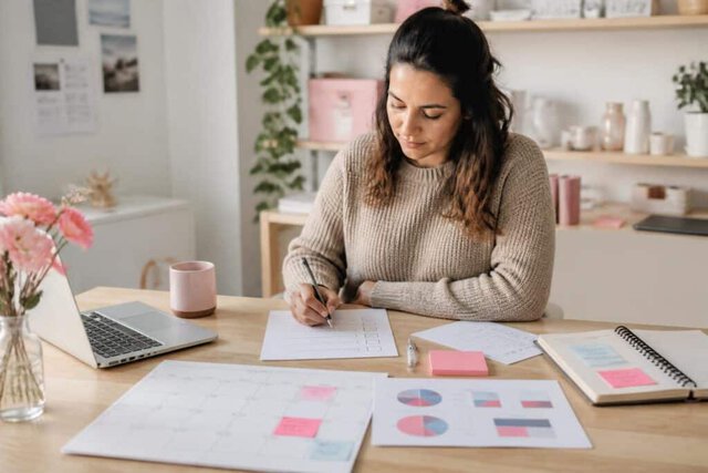 Small-business owner planning a manageable monthly marketing routine.